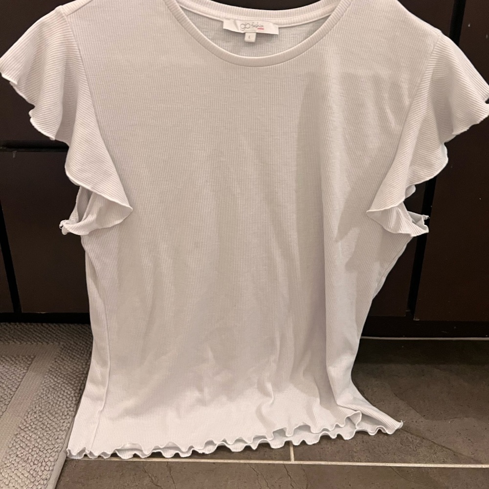 White blouse with ruffles on sleeves and bottom of shirt- tighter and cropped.